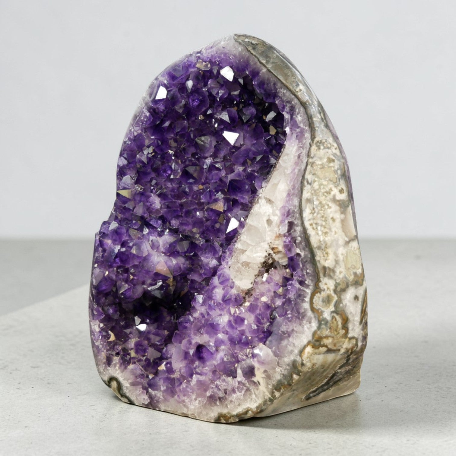 Deep purple amethyst cluster 33.95 lb AAA grade, natural open formation with white quartz border, ethically sourced from Artigas Uruguay, self-standing on wooden table