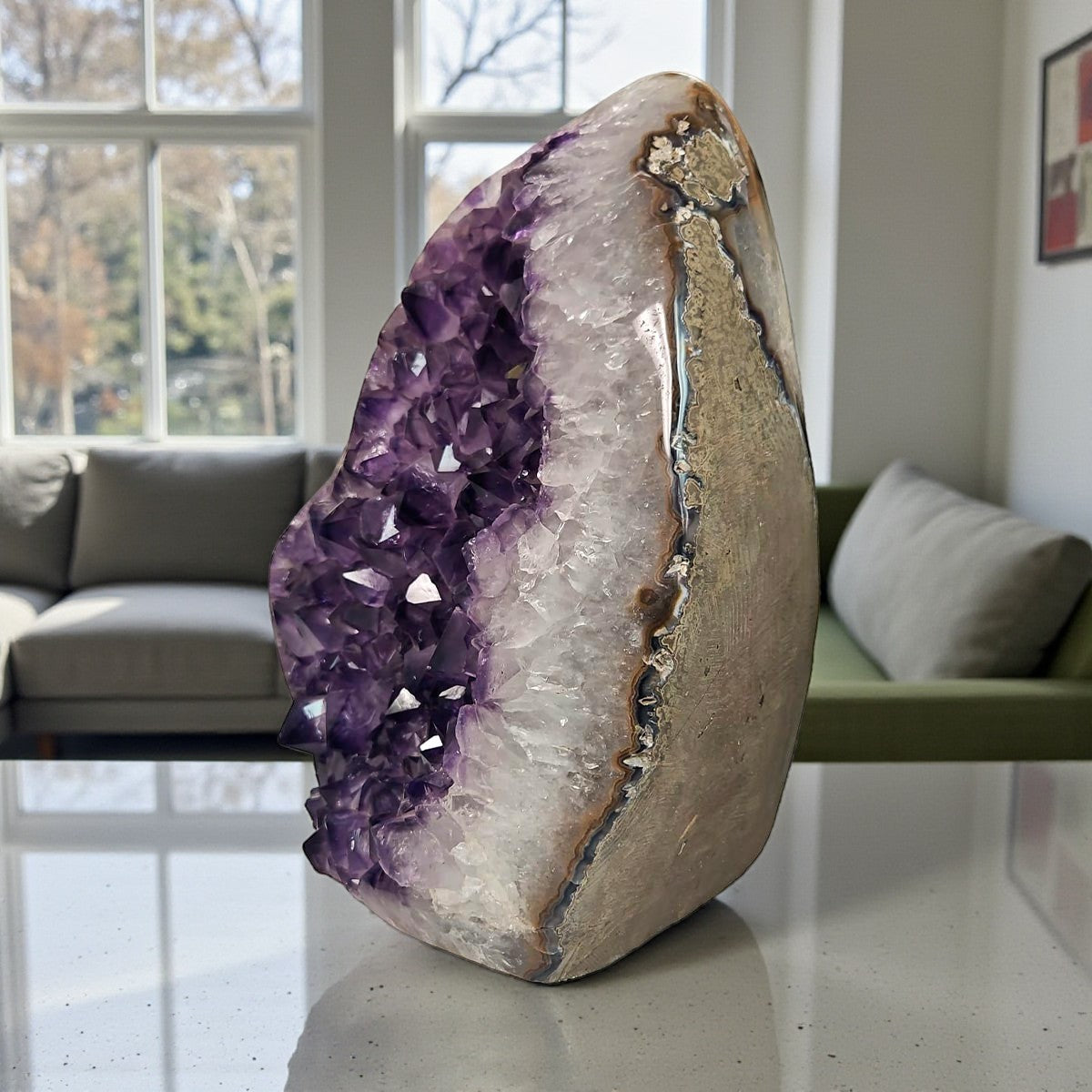 Side view of an amethyst rock with violet crystal cavity, white quartz banding, and natural agate layers.