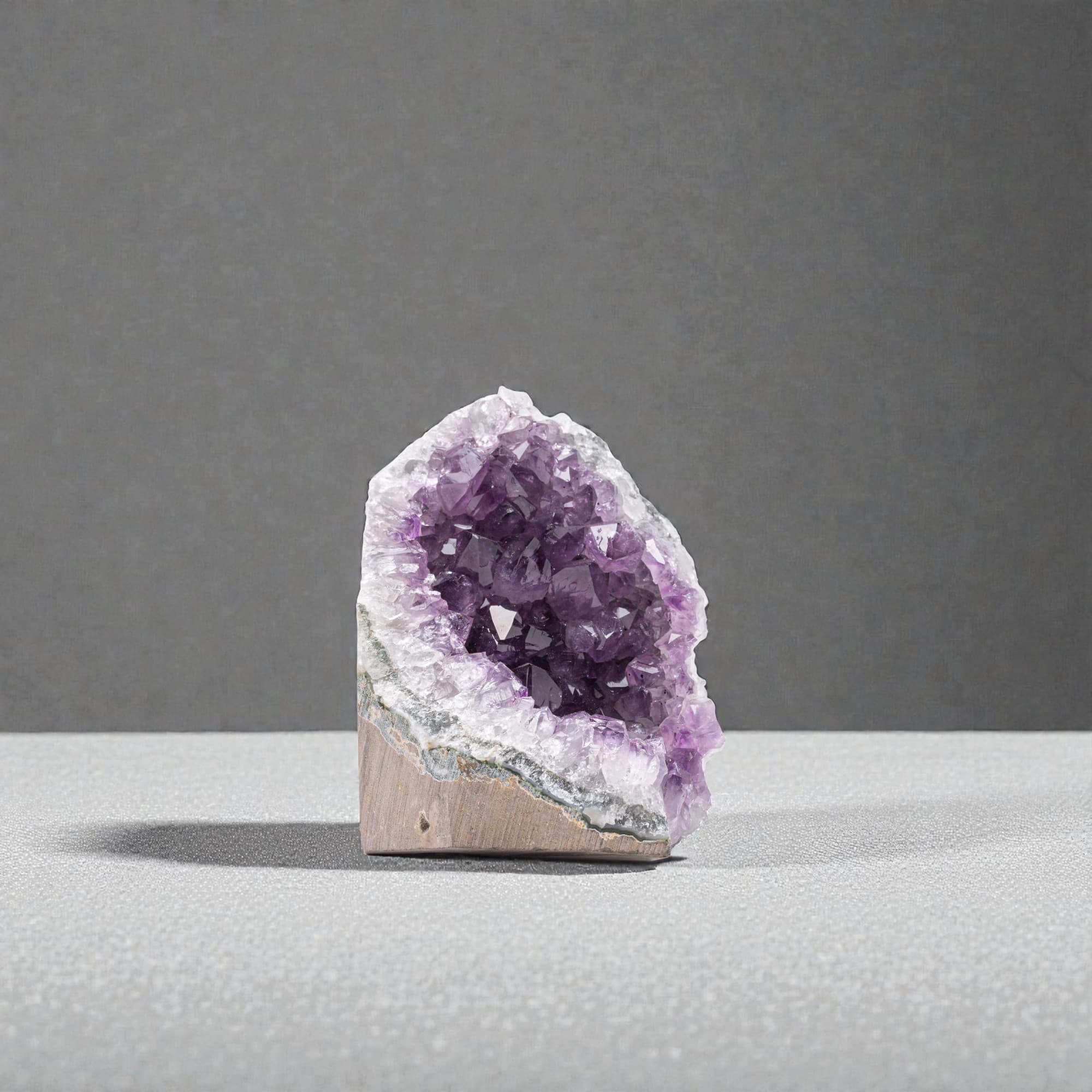 Side view of authentic Uruguay amethyst cluster under 1 lb highlighting dense crystal points and rich violet color.