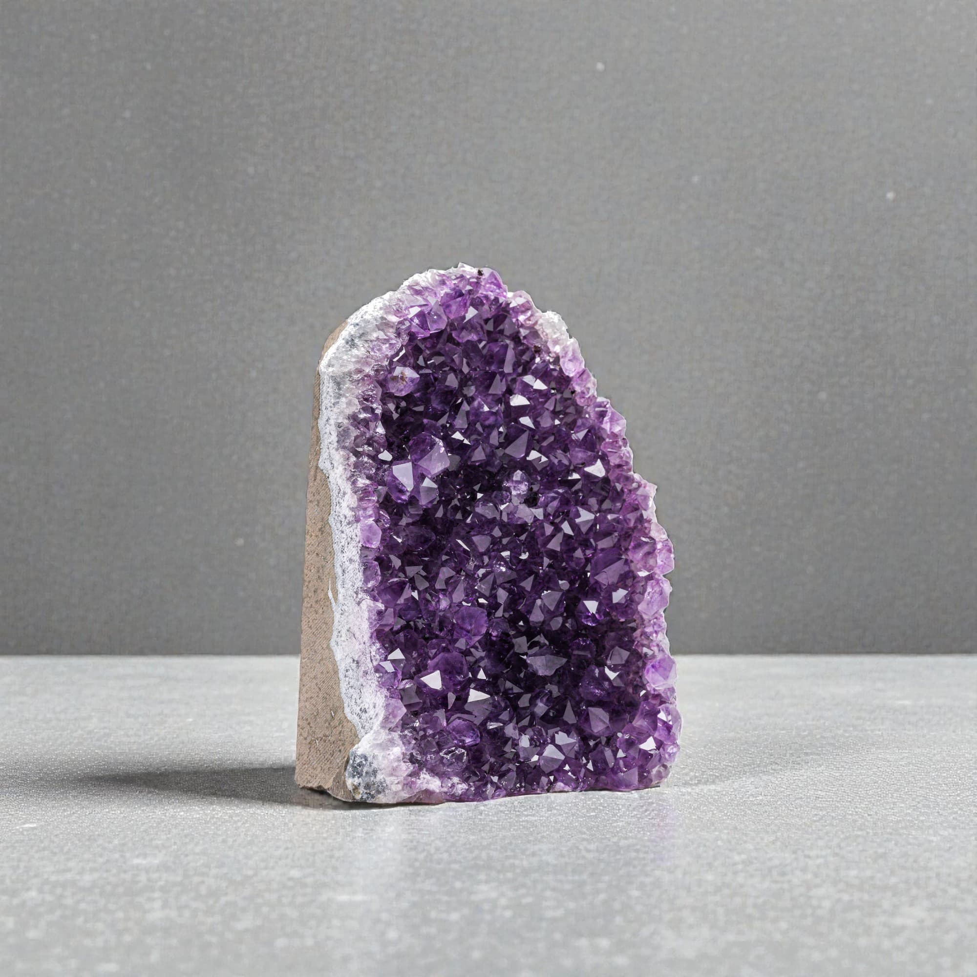 Decor purple gemstone, selfstand. Rock with rich crystal formations with unique amethyst textures